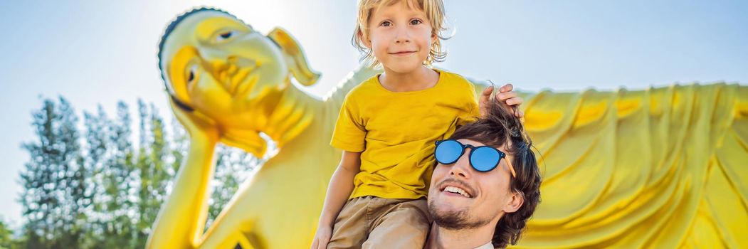 Happy tourists dad and son on background ofLying Buddha statue. BANNER, LONG FORMAT