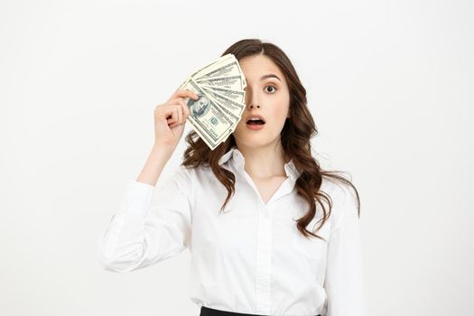 Portrait shocked young business woman standing and holding money isolated over white background