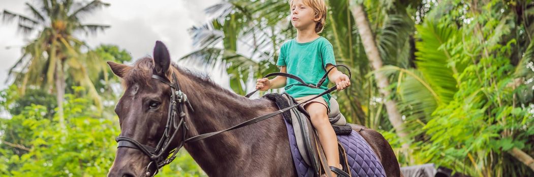 Boy horseback riding, performing exercises on horseback. BANNER, LONG FORMAT