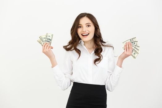 Portrait of a cheerful young business woman holding money banknotes and celebrating isolated over white background