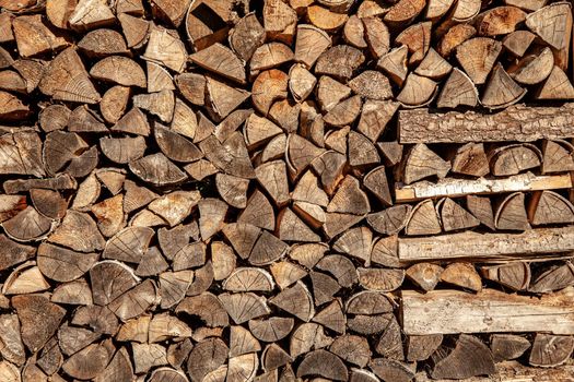 wall firewood , Background of dry chopped firewood logs in a pile.