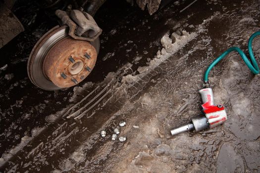 a car without a wheel, a bolt loosening gun wheel bolt