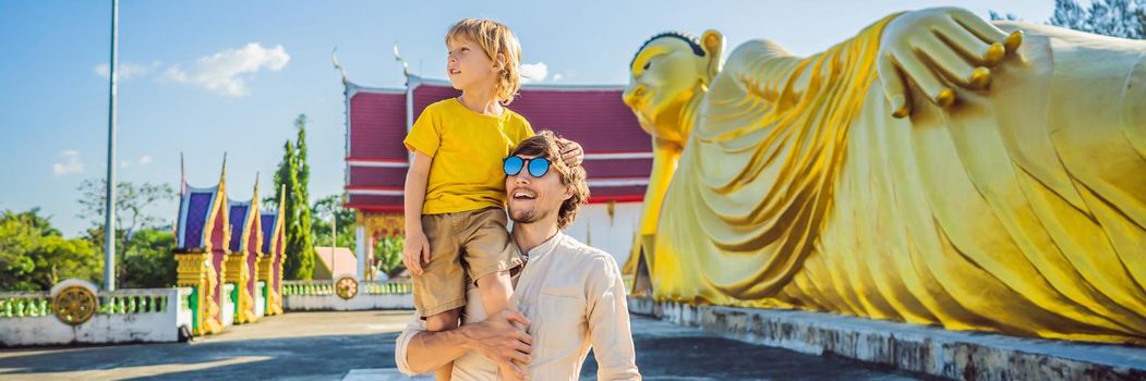 Happy tourists dad and son on background ofLying Buddha statue. BANNER, LONG FORMAT