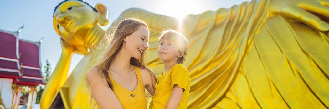 Happy tourists mother and son on background ofLying Buddha statue. BANNER, LONG FORMAT