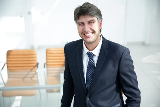 businessman standing by the desk. Business people