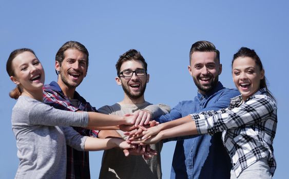 closeup.a team of young people shows their unity.photo with copy space