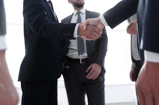 Successful business people handshaking after good deal.