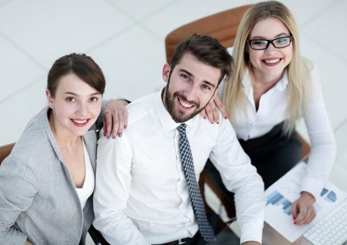 closeup of successful business team sitting at table and looking at camera.