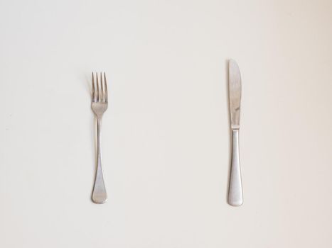 Food background - high angle view of fork and knife on white table