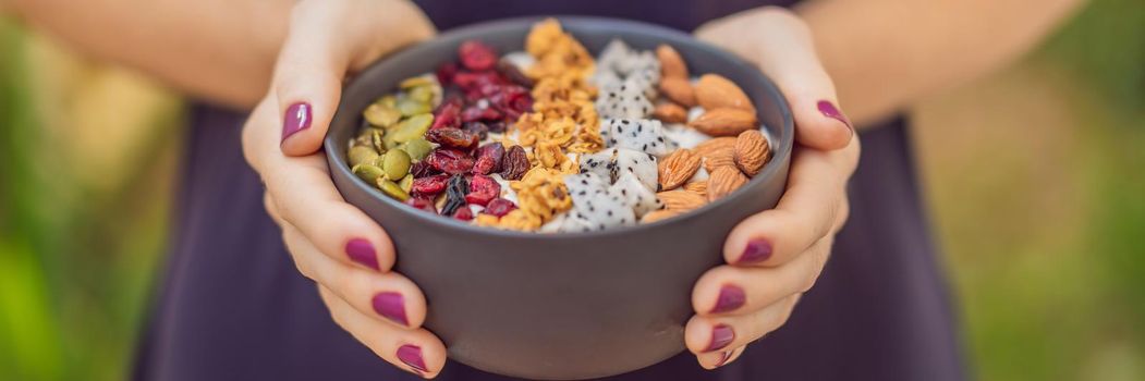 Women's hands are preparing a smoothie bowl. BANNER, LONG FORMAT