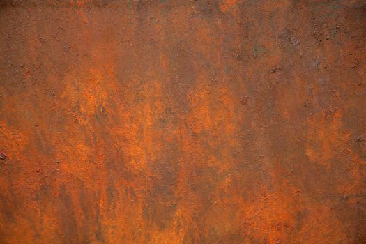 The texture of rusty metal is brown and orange