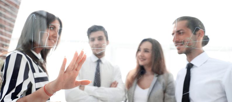 business team discussing a new presentation,standing in front of the glass Board