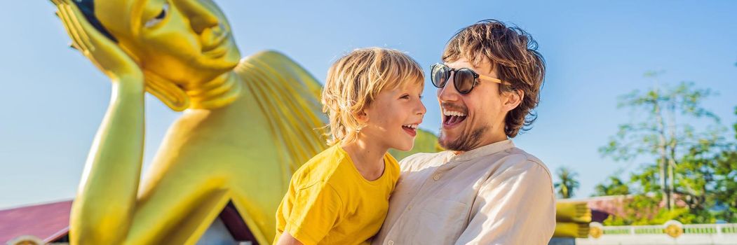 Happy tourists dad and son on background ofLying Buddha statue. BANNER, LONG FORMAT