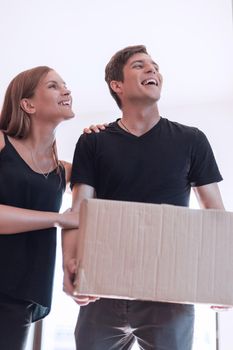 happy young family standing on the threshold of their new apartment