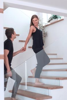 Romantic couple looking at each other while standing in new house. photo with copy space