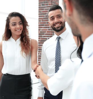 business women greet each other with a handshake before the start of the presentation.