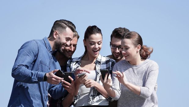 closeup. the group of students using smartphones.isolated on a blue background