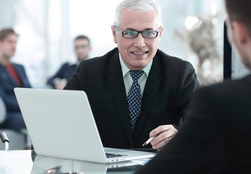 project Manager conducts an interview with a new employee in a modern office.