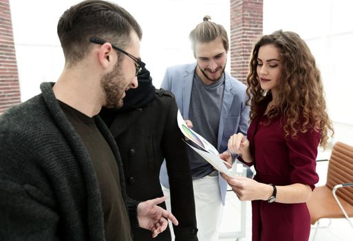 group of fashion designers discussing new spring clothing collection