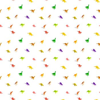 seamless pattern of toys of different small dinosaurs on a white background