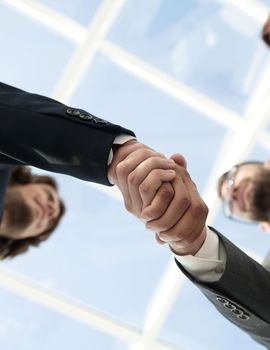 Close-up shot of businessmen shaking hands in the office
