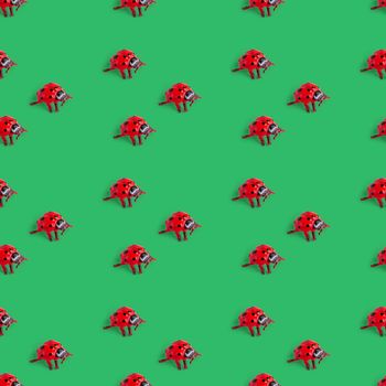 Seamless pattern with red ladybug on green background. holiday concept