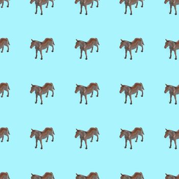 Seamless pattern photo of a toy horse on a blue background creative illustration.