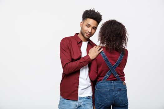 portrait of happy african american couple hug each other on white background