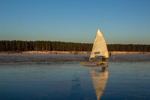 people ride and have fun on the frozen winter lake. winter entertainment