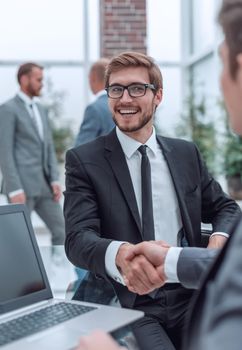 close up. handshake of business people near the office table . business concept