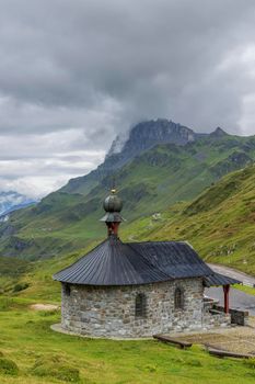 Bruder Klaus chapel, Typical alpine landscape of Swiss Alps near Klausenstrasse, Spiringen, Canton of Uri, Switzerland