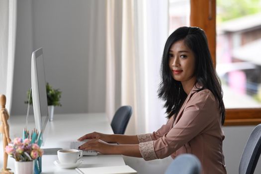 Asian woman office worker working at modern workplace.