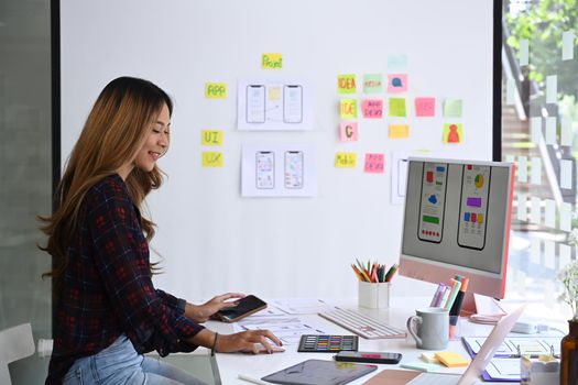 Side view of female web application developer working at modern office.