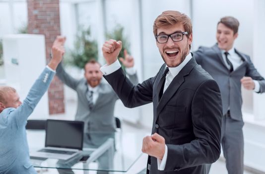 close up. jubilant entrepreneur standing in his office . photo with copy space