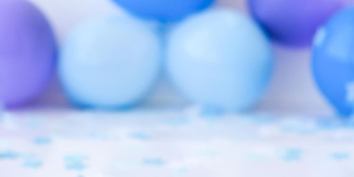 Abstract defocused blurred festive background for holiday. Birthday, boy or girl party concept. Baby shower Blue ballons and confetti. Copy space for text