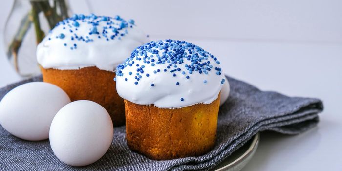 Happy Day Bright Easter. Orthodox Easter holiday. Traditional food. Creative stylish trend Homemade easter cake and eggs. Selective focus. Kulich Festive easter background Minimalism