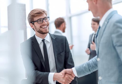 smiling businessman shaking hands with his business partner. concept of cooperation