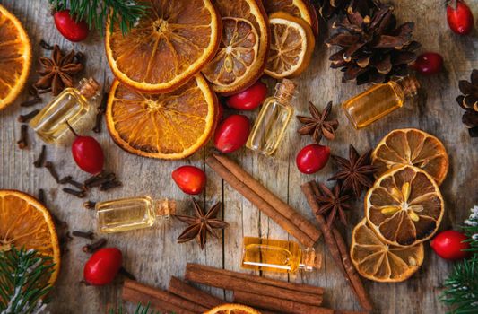 Christmas essential oils in small bottles. Selective focus. Nature.