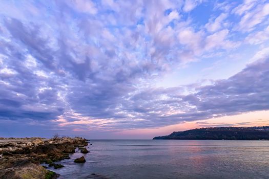 idyllic view with stunning clouds over the sea bay and pier 