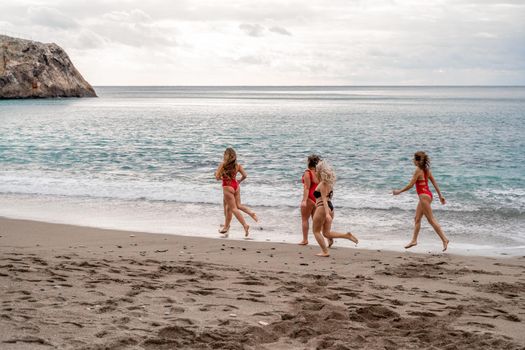 Big happy family or group of five friends is having fun against sunset beach. Beach holidays concept