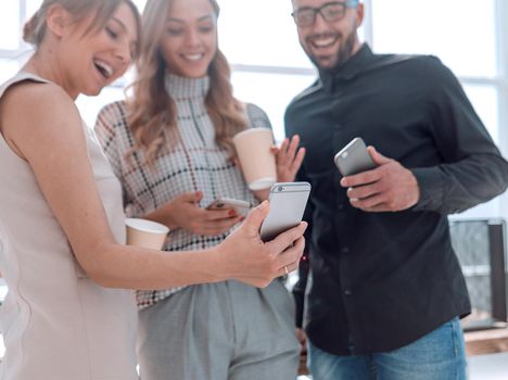 business team reading emails on their smartphones. people and technology