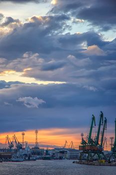 In the evening, the part of port with cranes.Ready to load containers from cargo ships.