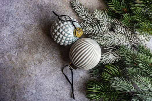 Christmas card concept with ceramic ball and ribbon on grey concrete background