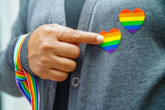 Asian woman with rainbow flag, LGBT symbol rights and gender equality, LGBT Pride Month in June.