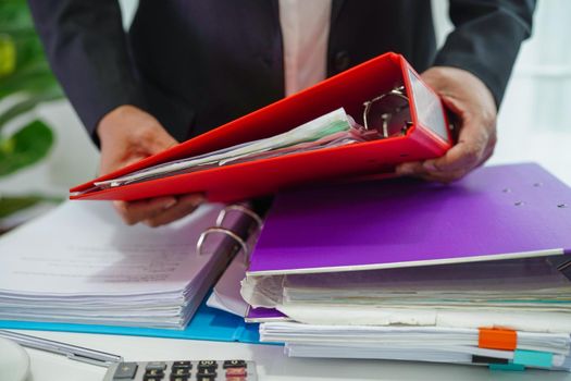 Businessman working and prepare paperwork report data to analysis information in file binder at office.
