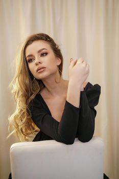 Beautiful young blonde woman face closeup portrait in studio on a light background.