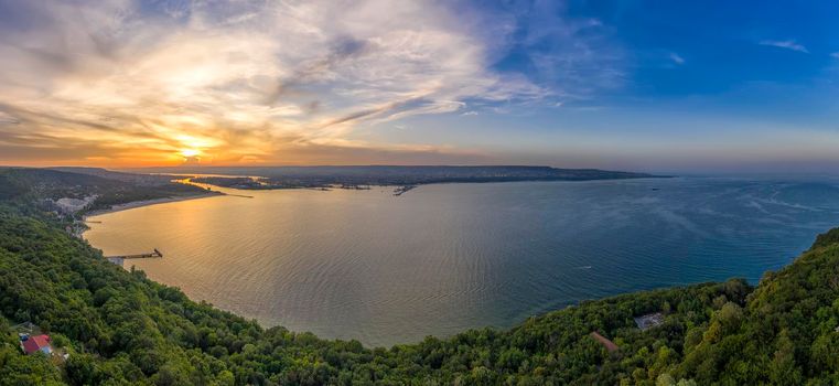 Dramatic sunset above the sea bay. Aerial drone view of sea and coastline of Varna, Bulgaria