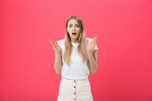 Surprised teenage student girl show shocking expression with something. Isolated on Bright Pink Background. Copy space.