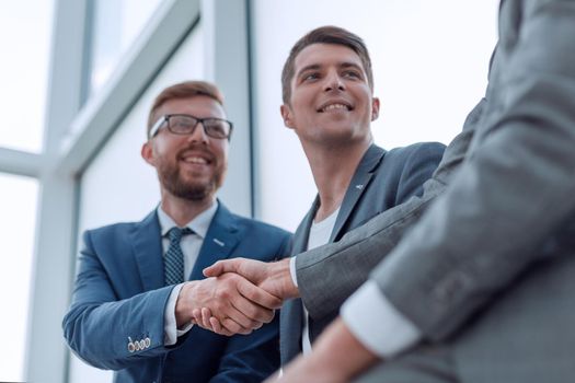 close up. smiling business colleagues shaking hands . business concept