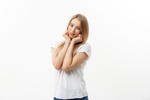Caucasian young woman with cute adorable playful shy smile. Model white t-shirt isolated on white background.